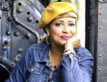 Vaneese Thomas ’74, H’14 wearing a yellow hat looking at the camera